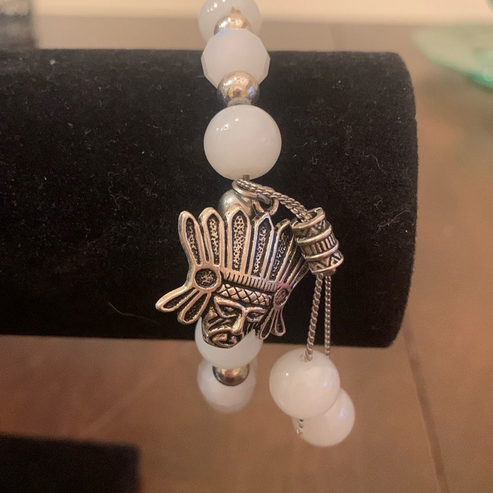 White and silver bracelet with Mayan charm